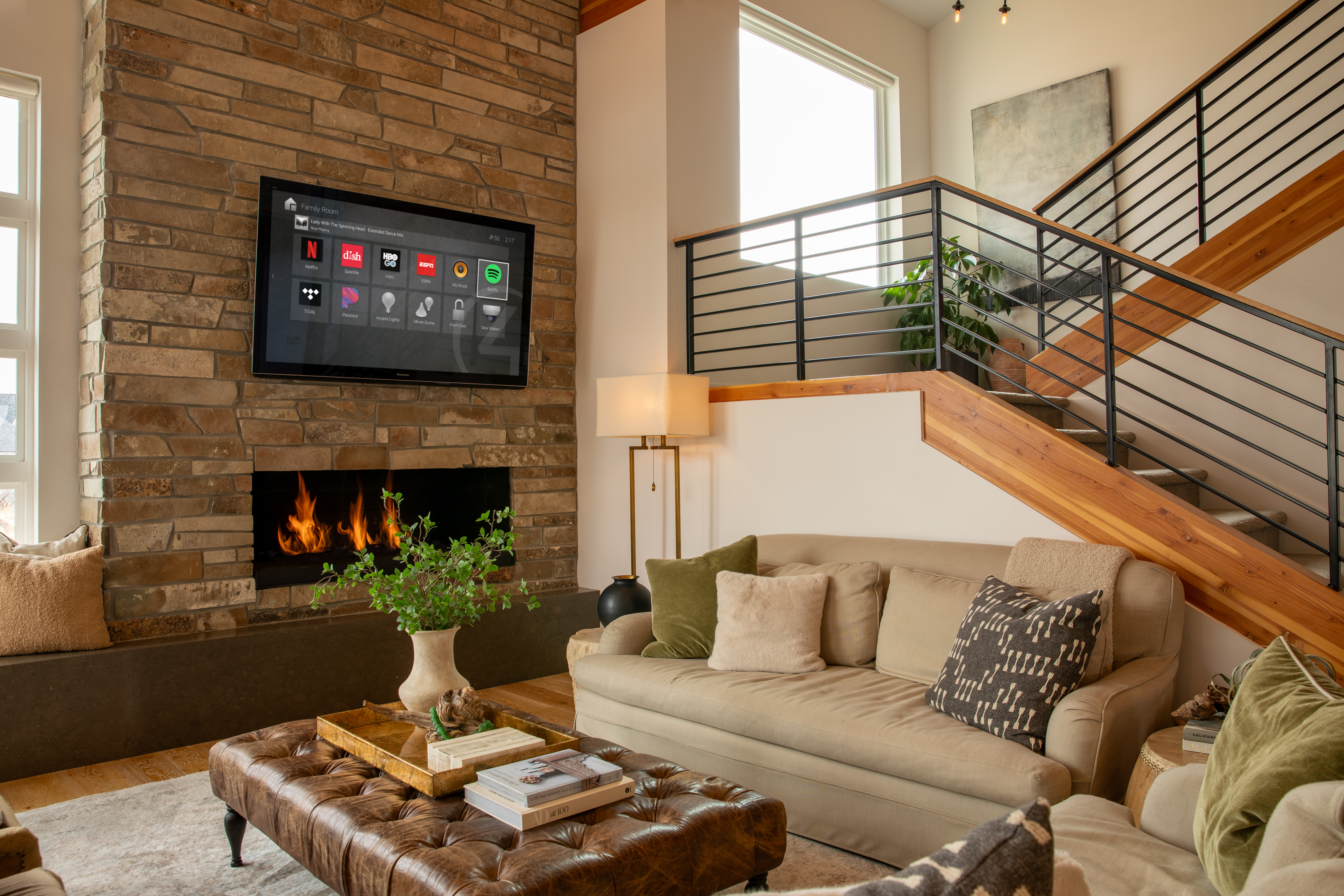 Living room with Control4 television above a stone fireplace