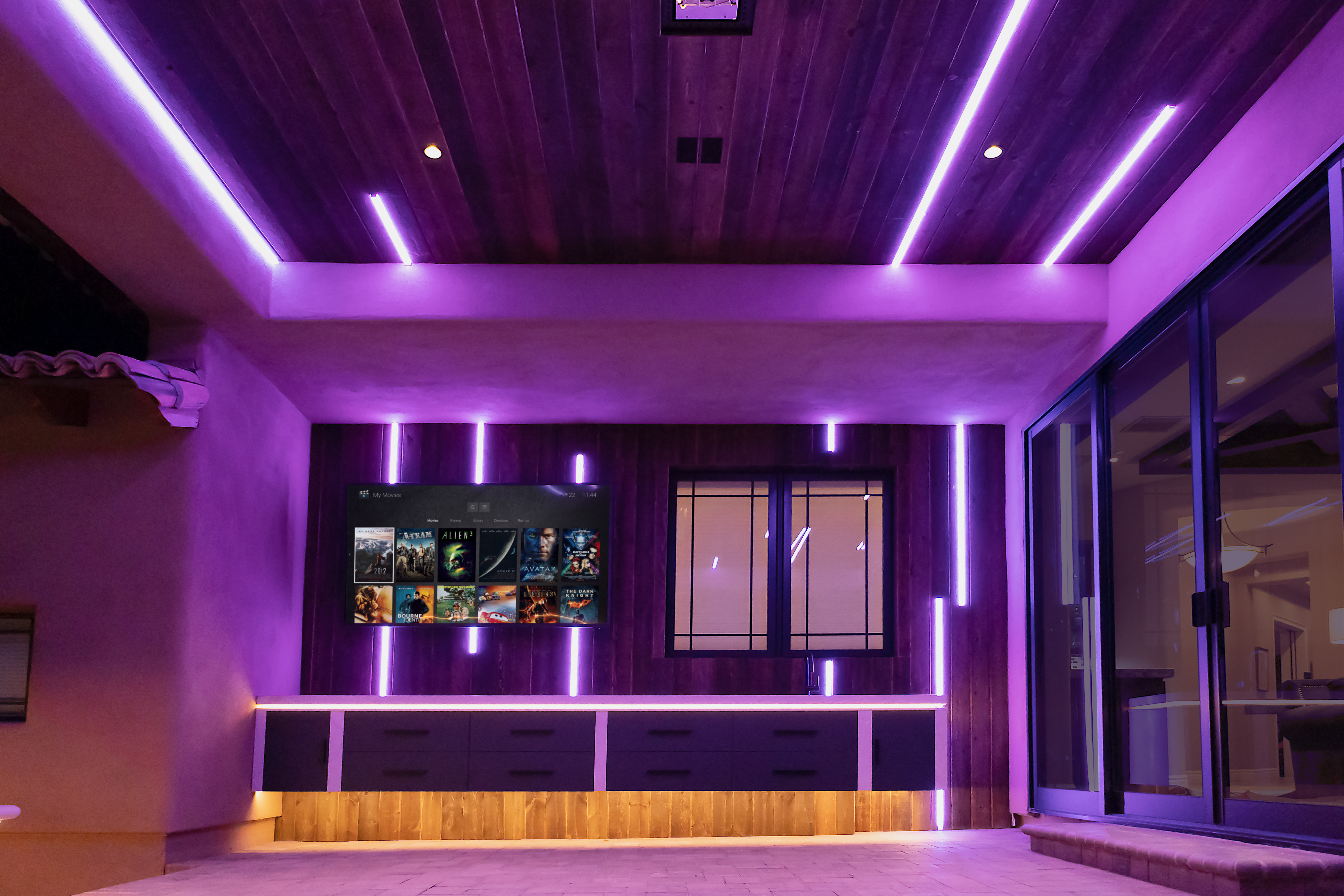 Outdoor media area with purple linear lighting